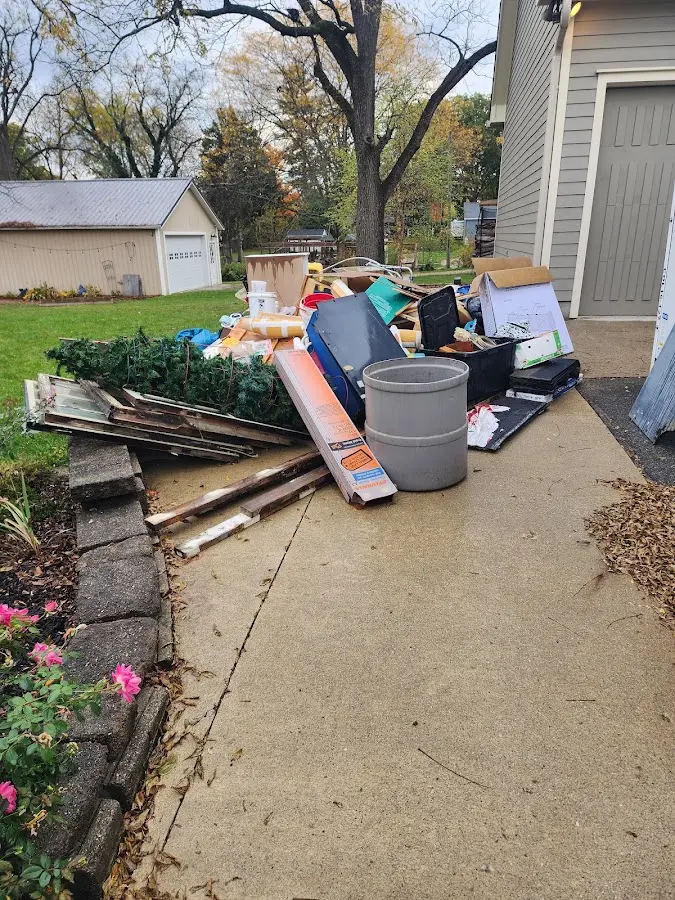Dumpster being loaded with debris for Estate Cleanout Dumpster Rental in Blakely
